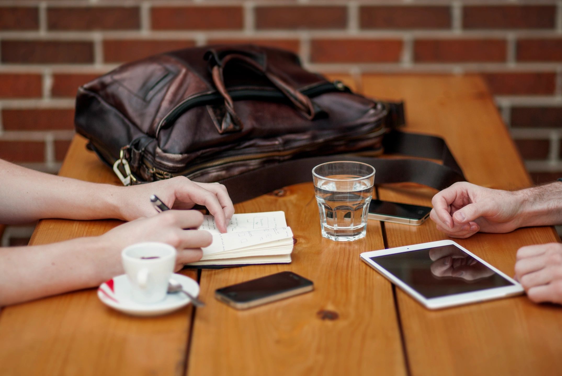 Business meeting at cafe with digital tablet and notebook.